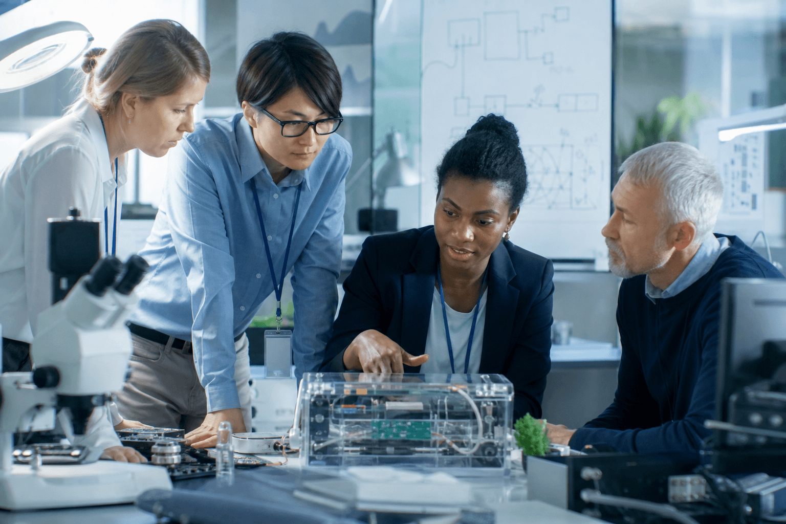 Researchers and engineers collaborating in an applied R&D setting